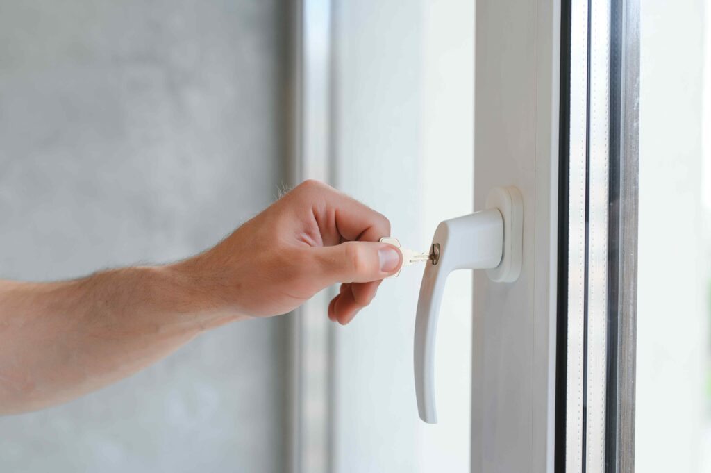 Man closing window